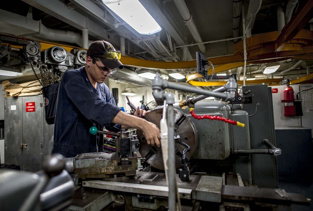 Machinist operating a lathe