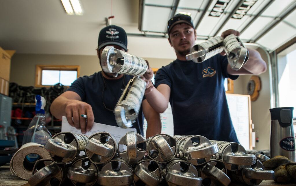 Machinists reviewing finished parts