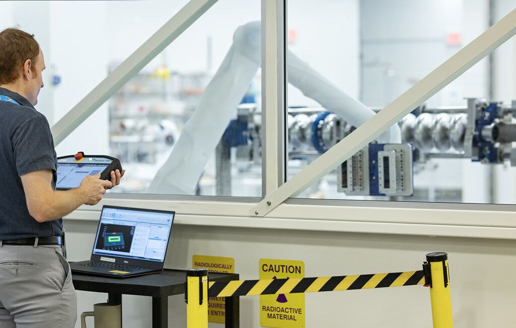 Technician running an automated assembly cell