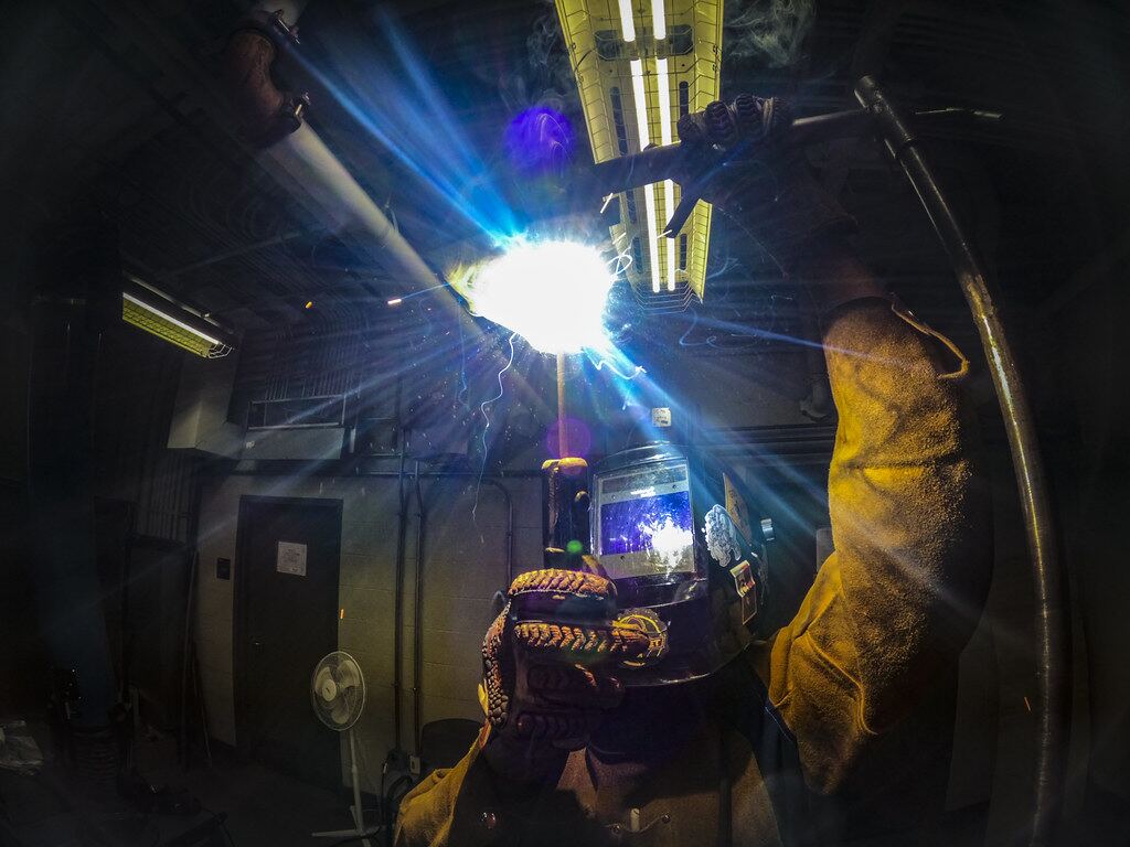 Welder working on a steel assembly